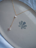 Minimal gold lariat pearl cross necklace flat lay with freshwater pearl and cross drop pendant, handmade coastal jewelry necklace