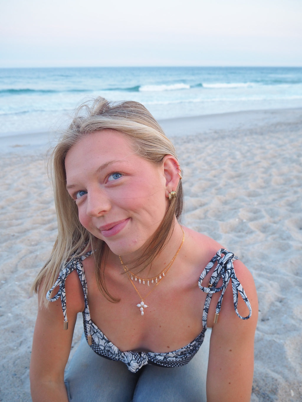Close-up of layered pearl drop necklace with pearl cross necklace, handmade gold beach jewelry necklace