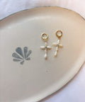 Dainty Pearl Cross Earrings handcrafted handmade jewelry displayed on ceramic dish