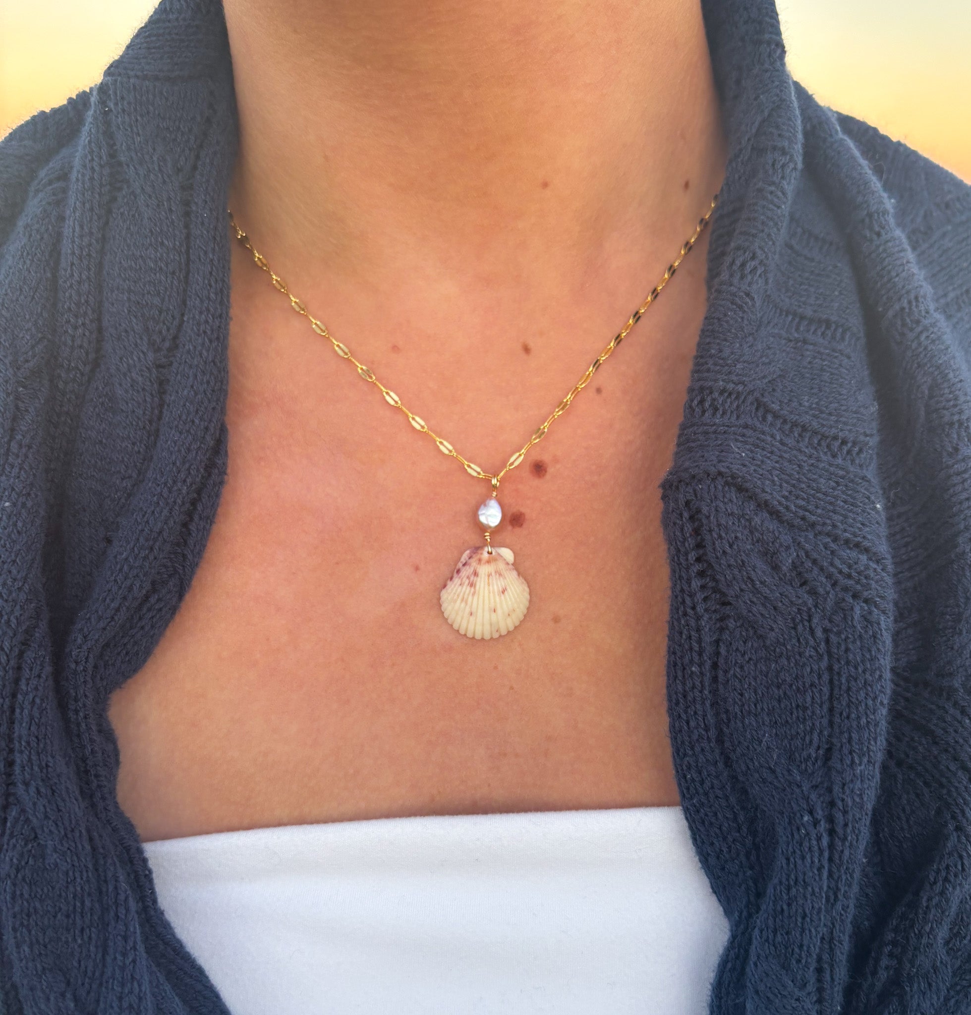 Rosie Bay Calico Scallop Necklace handmade jewelry worn on beach with pearl charm coastal necklace